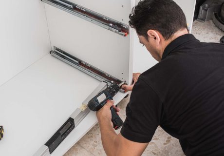 man-fixing-kitchen-cabinet-rails-with-a-drill-2022-05-03-23-15-10-utc.jpg